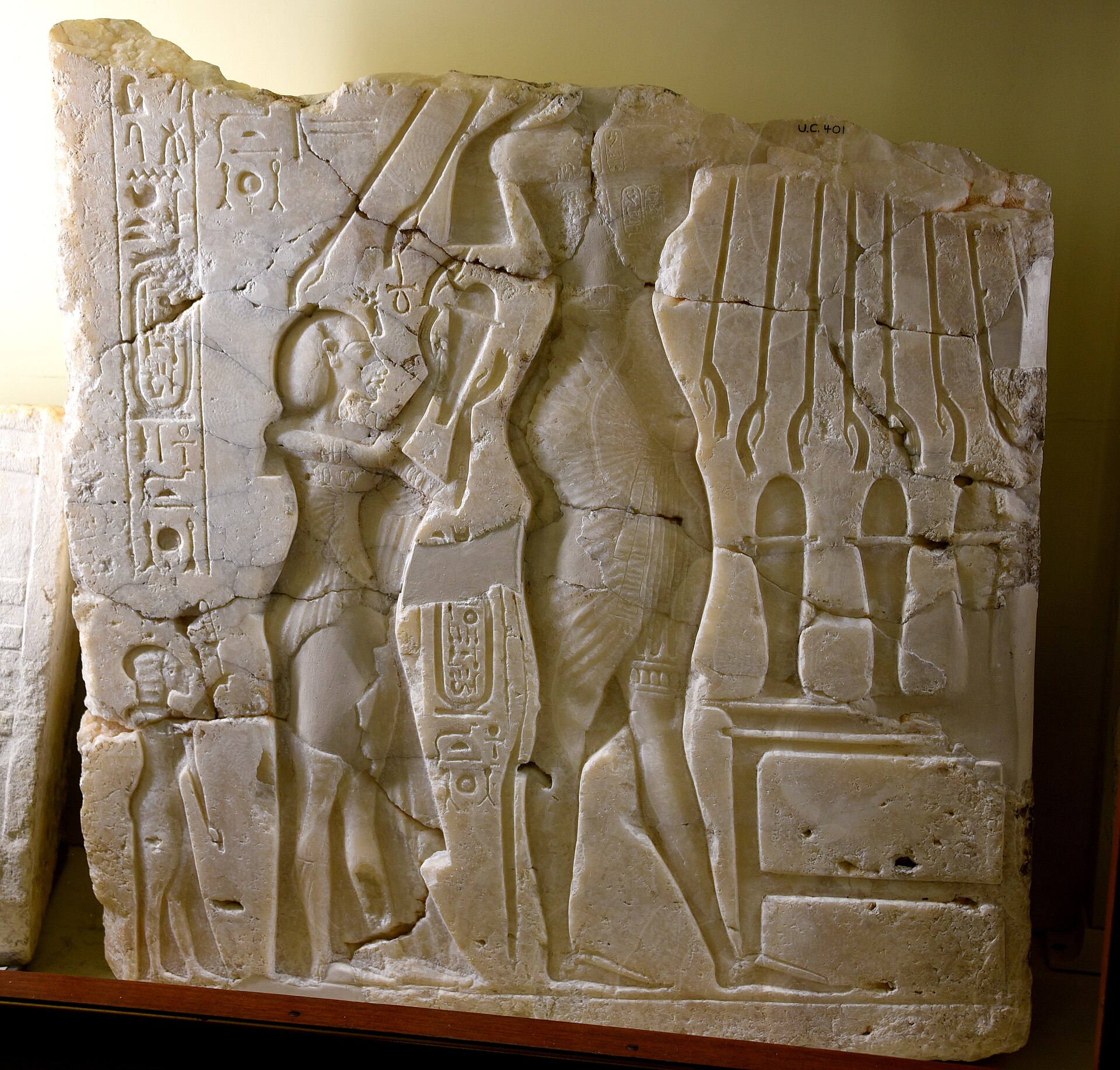 Alabaster sunken relief depicting Akhenaten (head lost), Nefertiti, and daughter Meritaten. Early Aten cartouches on king's arm and chest. From Amarna, Egypt. 18th Dynasty.The Petrie Museum of Egyptian Archaeology, Londo