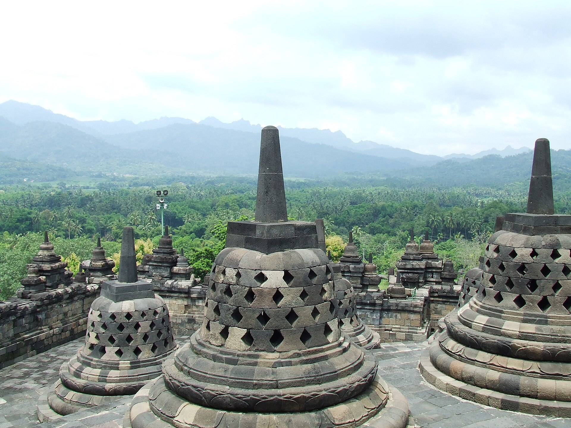 Borobudur stupas overlooking a mountain. For centuries, it was deserted