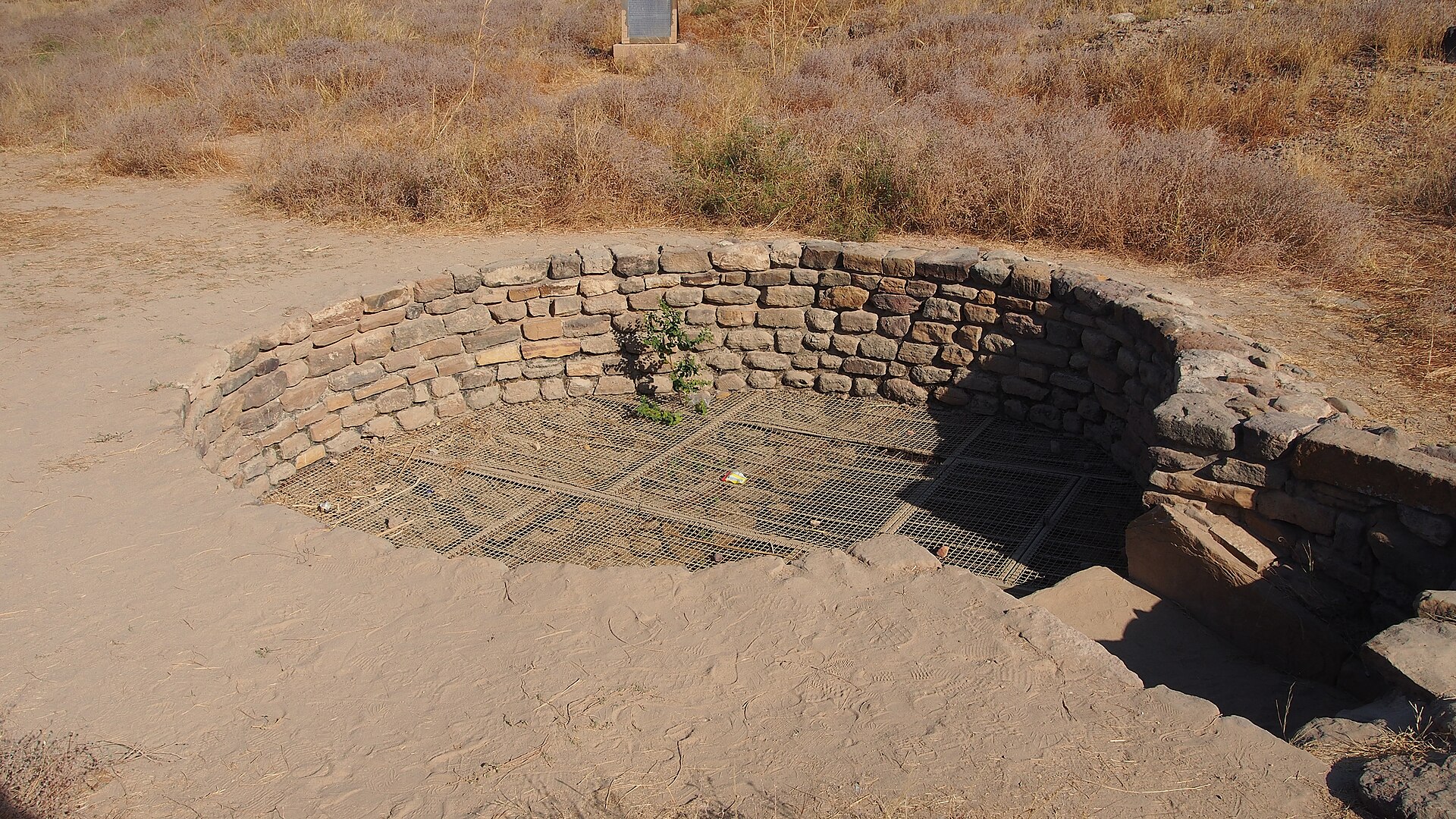 The well is a part of the water structures at the Castle of the ancient Harappan city of Dholavira. This well, is the largest found so far among ancient Harappan cities. It has an internal diameter of 4.25 meters, with e
