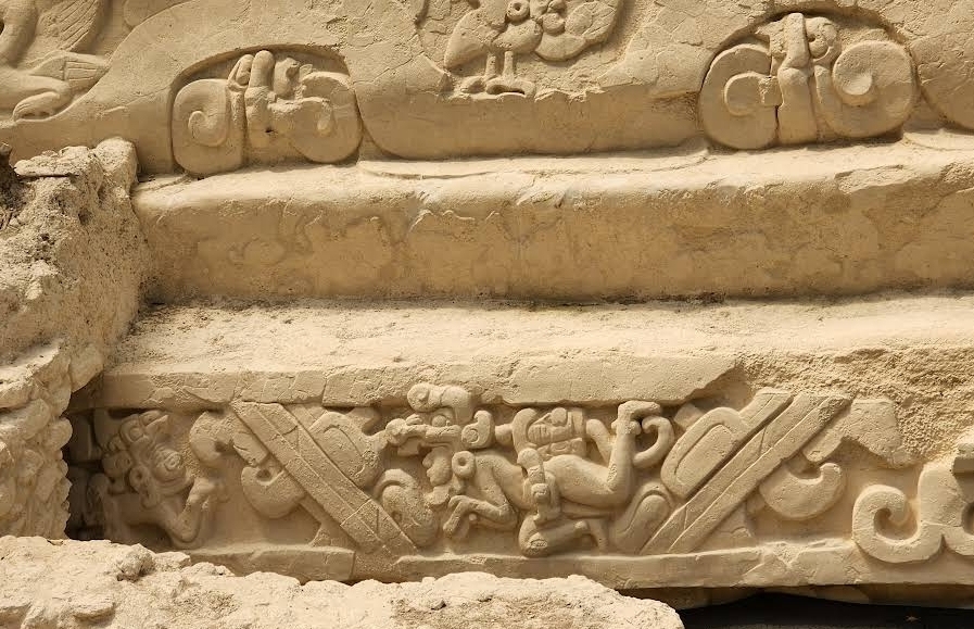 Carved stone relief depicting a Maya deity or supernatural figure from El Mirador, Guatemala. Dating to the Late Preclassic period (c. 300 BCE - 250 CE), this relief demonstrates the sophisticated religious and artistic