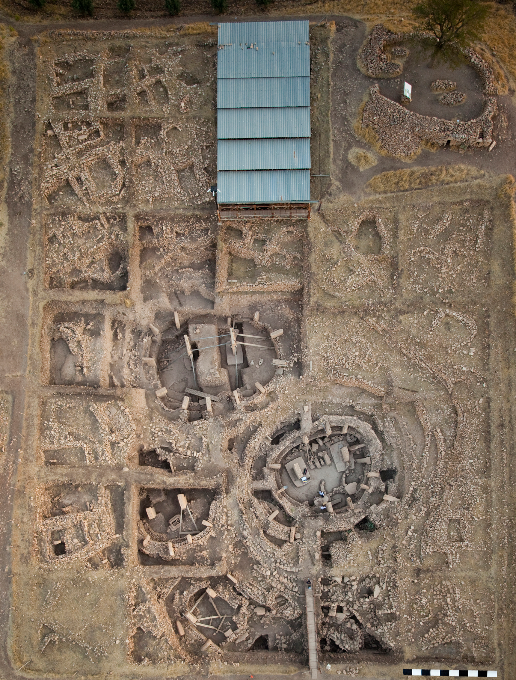 The archaeological site of Göbekli Tepe: main excavation area with four monumental circular buildings and adjacent rectangular buildings (German Archaeological Institute, photo E. Kücük).