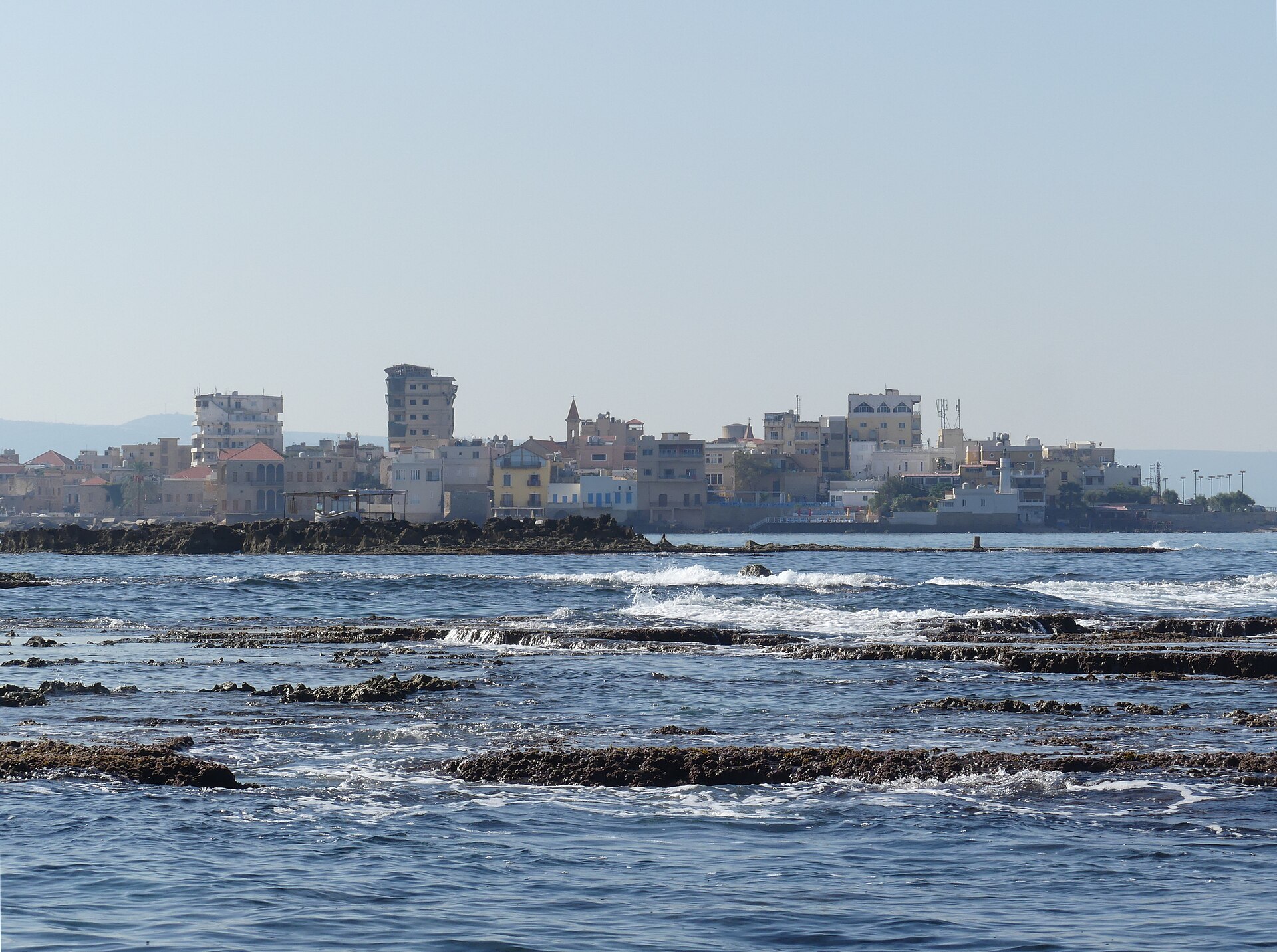 A group of rocky islands off the Western shore of the Tyre/Sour peninsula, Southern Lebanon, with the skyline of the Christian quarter in the background.