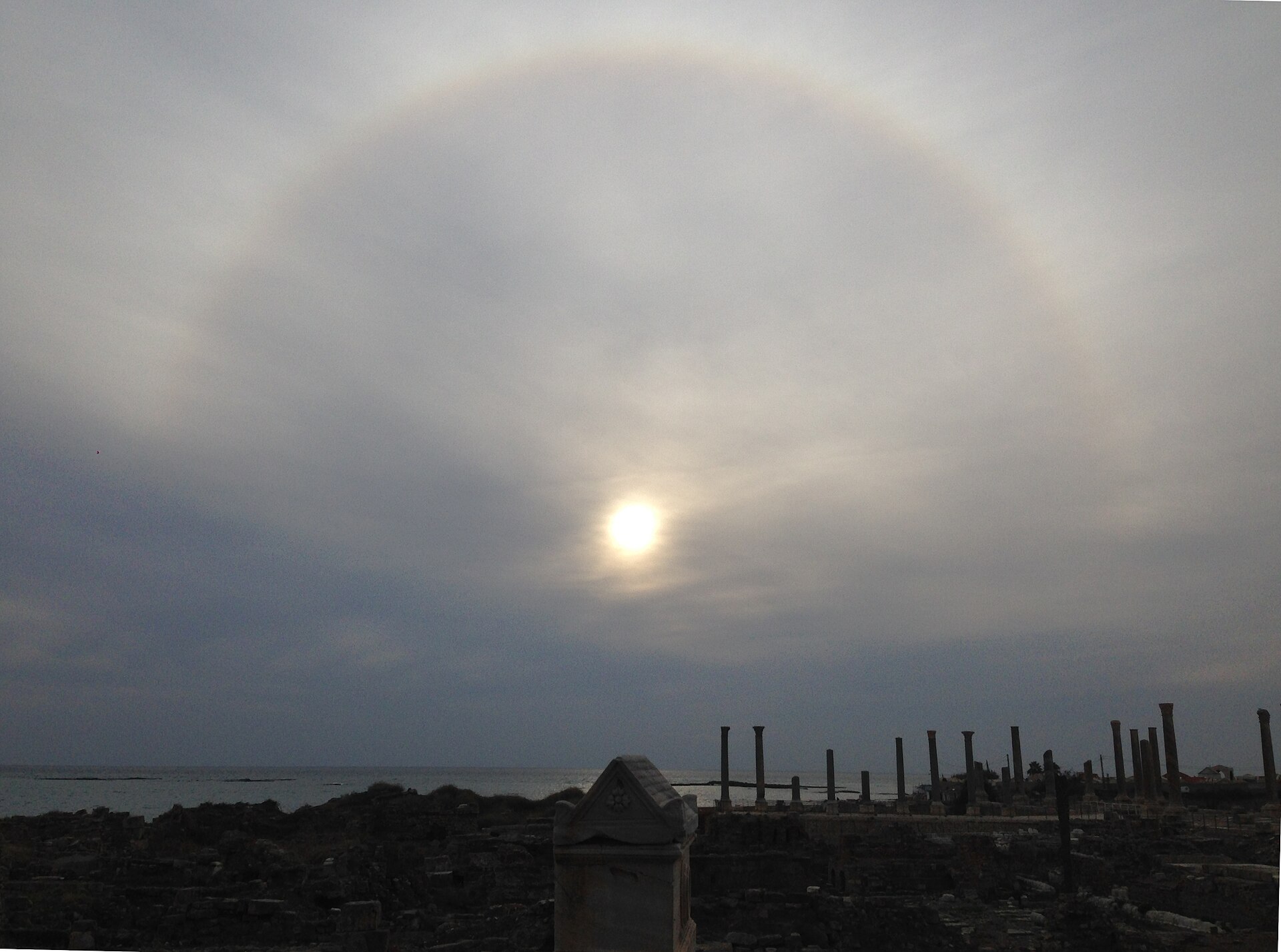 A 22° halo over the UNESCO World Heritage archaeological site of Al Mina (City site) on Southwestern side of Tyre/Sour peninsula, Southern Lebanon, with the Roman period sarcophagus of one Antipater in the centre.